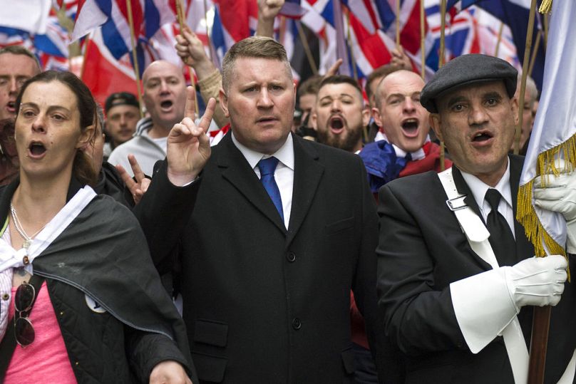 Leader of Britain First Paul Golding, center, gestures during a demonstration by Britain First and EDL (English Defence League) in London, Saturday, April 1, 2017.