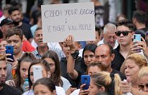 People hold banners during a rally in Romania by Roma organizations to honor a Stanislav Tomas, who was killed by police officers in the Czech Republic. 29 June 2021