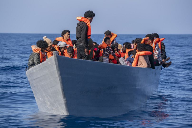 Migrants from Eritrea, Libya and Sudan crowd the deck of a wooden boat in the Mediterranean sea, about 30 miles north of Libya, June 2023