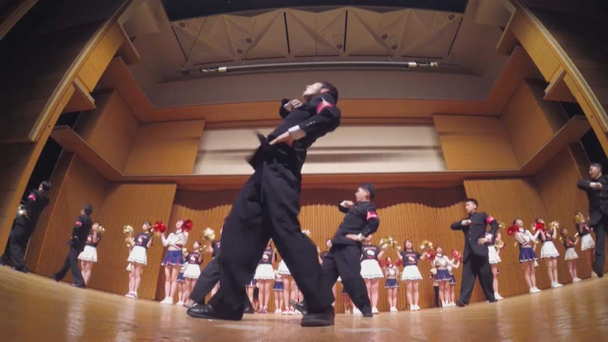 A 'leadership cheerleader' screams a traditonal Japanese chant on stage
