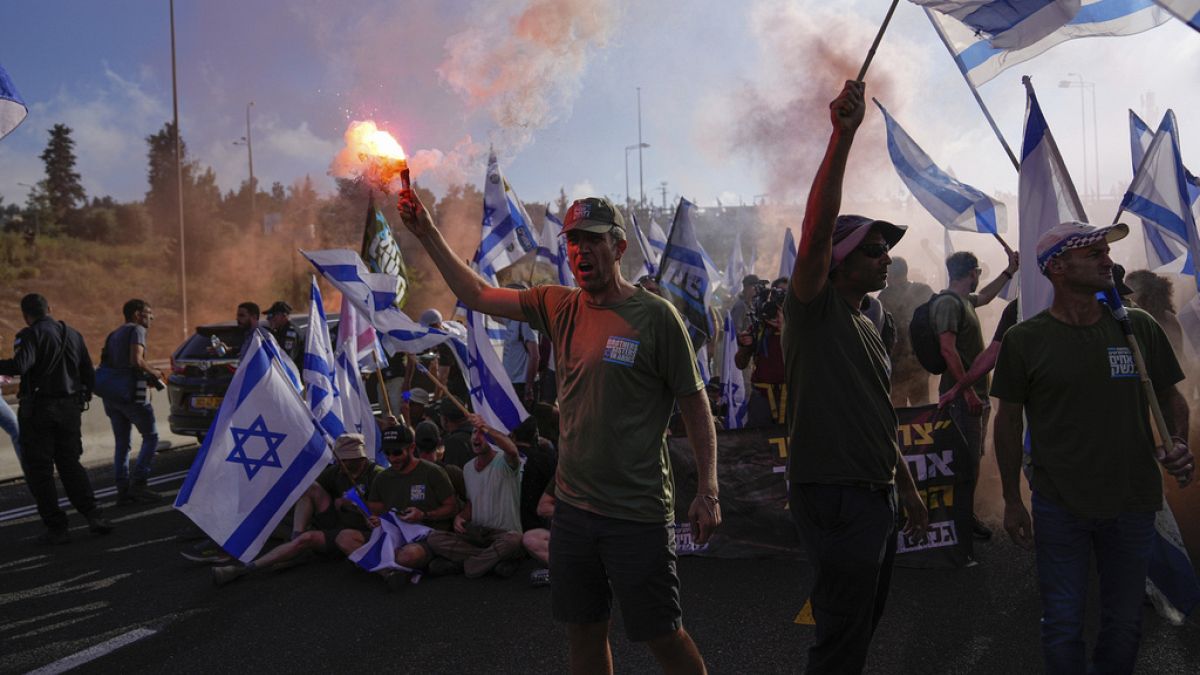 Demonstrators block a highway leading to Jerusalem, during a protest against plans by Prime Minister Benjamin Netanyahu's new government to overhaul the judicial system.