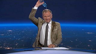 Un presentador austriaco se vacía una botella de agua.