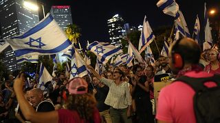 Woman waves Israeli flag during protests in Tel Aviv, Israel, against the government's judicial reform