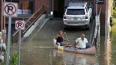 Residents in Montpelier, Vt use a canoe to remove surgical supplies from the flood-damaged centre, Tuesday, July 11, 2023