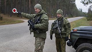 Lithuanian soldiers patrol a road near the Lithuania-Belarus border near the village of Jaskonys, Druskininkai district some 160 km south of the capital Vilnius, 13 Nov 2023