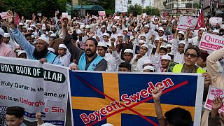 Muslim protesters hold copies of the book 'Quran' as they chant slogans to denounce the burning of the Quran that took place in Sweden, in Pakistan. 9 July 2023