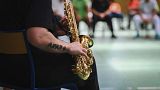 An inmate plays a saxophone as he performs with professional musicians during a jazz concert held at Saint-Quentin-Fallavier prison in Saint-Quentin-Fallavier, eastern France.