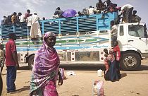  People board a truck as they leave Khartoum, Sudan, on June 19, 2023.