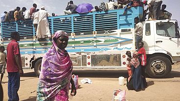  People board a truck as they leave Khartoum, Sudan, on June 19, 2023. 
