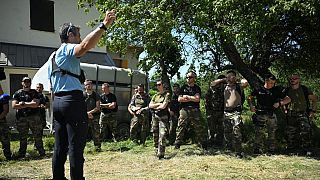 French gendarmes are briefed before taking part in a search operation for two-and-a-half-year-old Emile who is reported missing for two days, on July 10, 2023