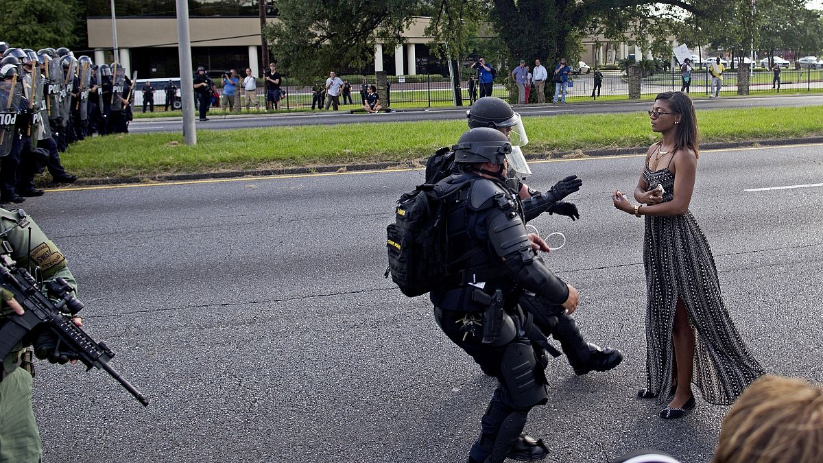 A lone protestor confronts a line of police in Baton Rouge