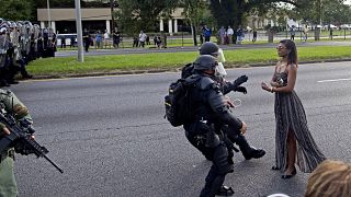 A lone protestor confronts a line of police in Baton Rouge