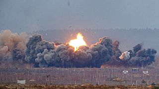 Smoke and flame rise over a field during the Union Courage-2022 Russia-Belarus military drills at the Obuz-Lesnovsky training ground in Belarus, Saturday, Feb. 19, 2022.