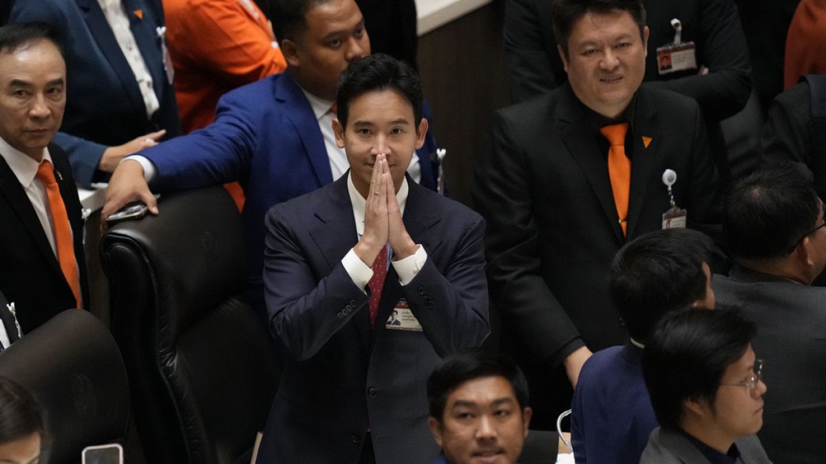 Pita Limjaroenrat, center, the leader of Move Forward Party and top winner in the May's general election, reacts after the vote counting at the Parliament in Bangkok.