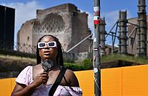 A woman cools off with a mini fan in Rome, on July 14, 2023, as Italy is hit by a heatwave.