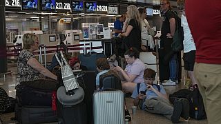 Passengers wait for the check-in of their flights during a nationwide strike of airports ground staff, and check-in services.