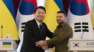 South Korean President Yoon Suk Yeol, left, and Ukrainian President Volodymyr Zelenskyy stand for photos after delivering statements