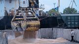 FILE - Workers load grain at a grain port in Izmail, Ukraine, on April 26, 2023.