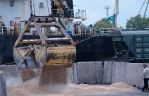 FILE - Workers load grain at a grain port in Izmail, Ukraine, on April 26, 2023.
