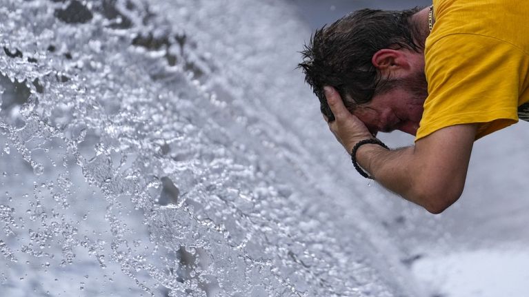 A man cools off at a fountain during a sunny day in Belgrade, Serbia A man cools off at a fountain during a sunny day in Belgrade, Serbia