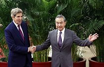 US climate envoy John Kerry, left, and Chinese top diplomat Wang Yi