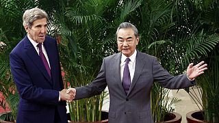 US climate envoy John Kerry, left, and Chinese top diplomat Wang Yi