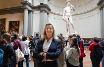 Cecilie Hollberg, director of the Accademia Gallery poses in front of Michelangelo's white marble statue "David" in Florence.
