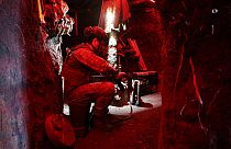 A Ukrainian serviceman from the K-2 battalion checks his weapon in a dugout in the Donetsk region, on July 12, 2023, amid the Russian invasion of Ukraine.