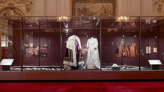 The coronation outfits worn by King Charles and Queen Camilla on display in Buckingham Palace's stunning ballroom