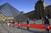 Republican Guards stand alongside the Louvre museum pyramid in Paris before a dinner to honour Indian Prime Minister Narendra Modi July 14