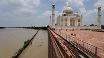 The Taj Mahal on the banks of the Yamuna river, India. 