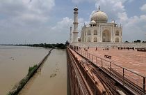 The Taj Mahal on the banks of the Yamuna river, India.