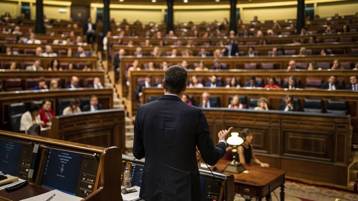 rime Minister Pedro Sánchez, center, gives a reply to United Podemos (United We Can) party leader Pablo Iglesias during the parliamentary debate at the Spanish parliament.