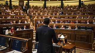 rime Minister Pedro Sánchez, center, gives a reply to United Podemos (United We Can) party leader Pablo Iglesias during the parliamentary debate at the Spanish parliament.