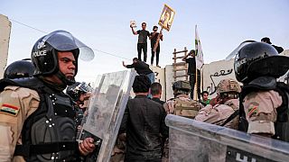 Iraqi riot police try to disperse supporters of Iraqi Shiite cleric Moqtada al-Sadr gathering for a protest outside the Swedish embassy in Baghdad on July 20, 2023.