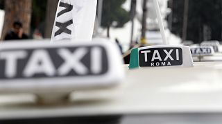 Taxi are aligned up next to Rome's Circus Maximus ancient arena during a drivers' strike against the government's plans to issue more taxi licenses, Jan. 23, 2012.