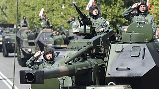 Polonya'nın başkenti Varşova'da askeri geçit töreninde tanklarla geçen Polonyalı askerler