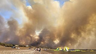 Clouds of smoke from a forest fire rise to the sky on the island of Rhodes, Greece, Saturday, July 22, 2023.