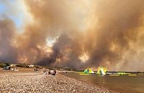 Des nuages de fumée provenant d'un feu de forêt s'élèvent dans le ciel de l'île de Rhodes, en Grèce, le samedi 22 juillet 2023.