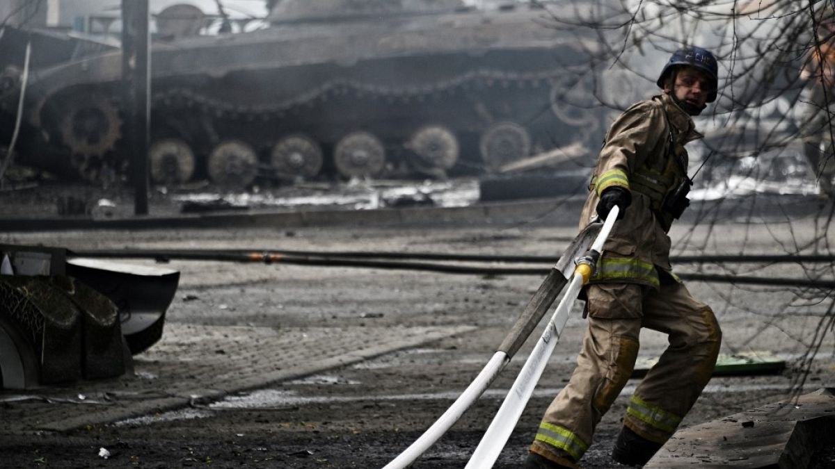 A Ukrainian firefighter works to extinguish a fire at a petrol station, July 2023.
