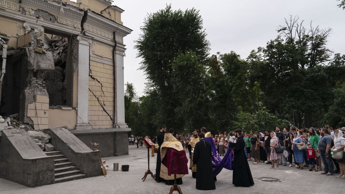 People attend a Mass outside the Odesa Transfiguration Cathedral after it was heavily damaged in Russian missile attacks in Odesa, Ukraine, Sunday, July 23, 2023. 