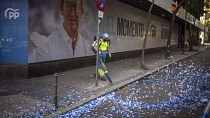 A worker cleans the street after celebrations at the conservative Popular Party headquarters in Madrid, Spain, Monday, July 24, 2023.