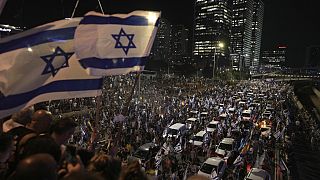 Demonstrators block the traffic on a highway crossing the city during a protest against plans by Netanyahu's government to overhaul the judicial system, in Tel Aviv, Monday.