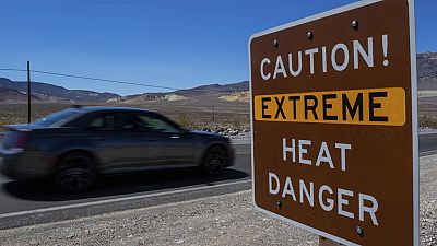 FILE - Warning sign in Death Valley National Park, California, USA July 11, 2023