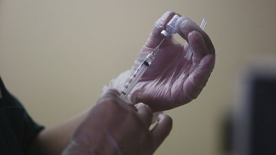 A syringe with the Pfizer COVID-19 vaccine