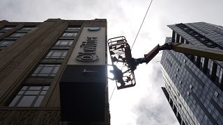 A workman removes characters from a sign on the Twitter headquarters building in San Francisco, Monday, July 24, 2023.