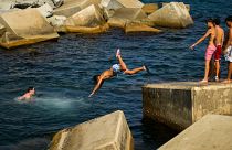 Youngsters dive into the Mediterranean sea during a hot day in Barcelona, Spain, 21 July 2022.