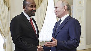 Russian President Vladimir Putin, right, and Ethiopian Prime Minister Abiy Ahmed shake hands during a meeting on the eve of the Russia Africa Summit in St. Petersburg, Russia