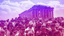 Atop the Acropolis ancient hill, tourists visit the Parthenon temple, background, in Athens, July 2023