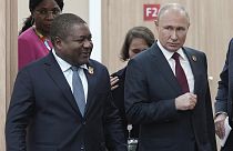 Russian President Vladimir Putin, right, and Mozambique President Filipe Nyusi arrive for a meeting on the sidelines of the Russia-Africa Summit